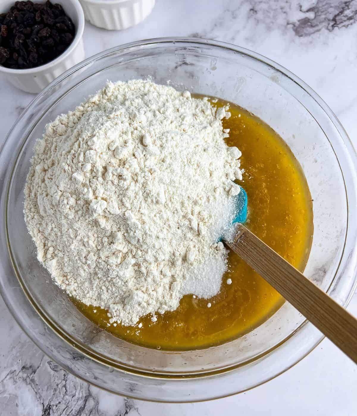 Combining flour mixture into the wet mixture to make a bread.