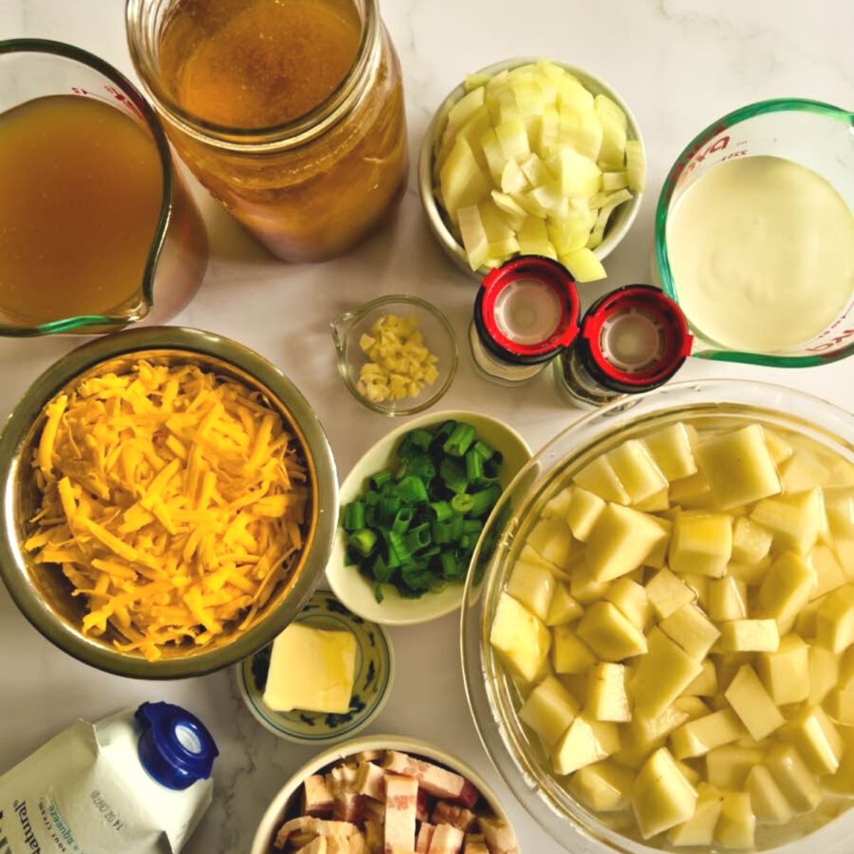 Ingredients for cheesy potato bacon soup on the table