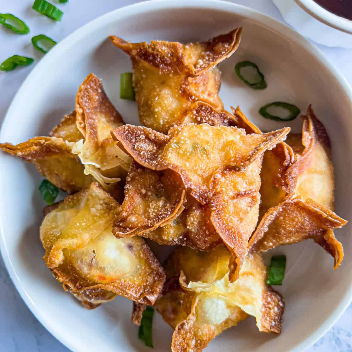 Finish dish of crab rangoon on the table.