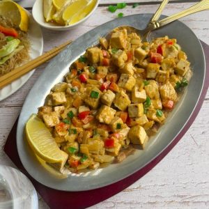 Sisig tofu in a plate sliced of lemons.