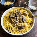 A bowl of mushroom carbonara on table.