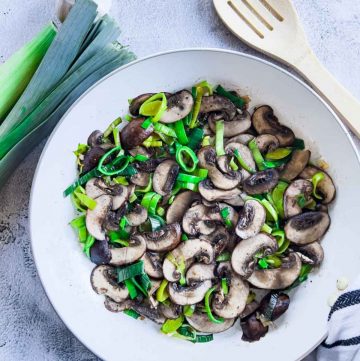 Sauteed garlic, mushrooms and leeks on a skillet.