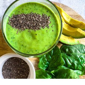 An avocado spinach smoothie on a table.