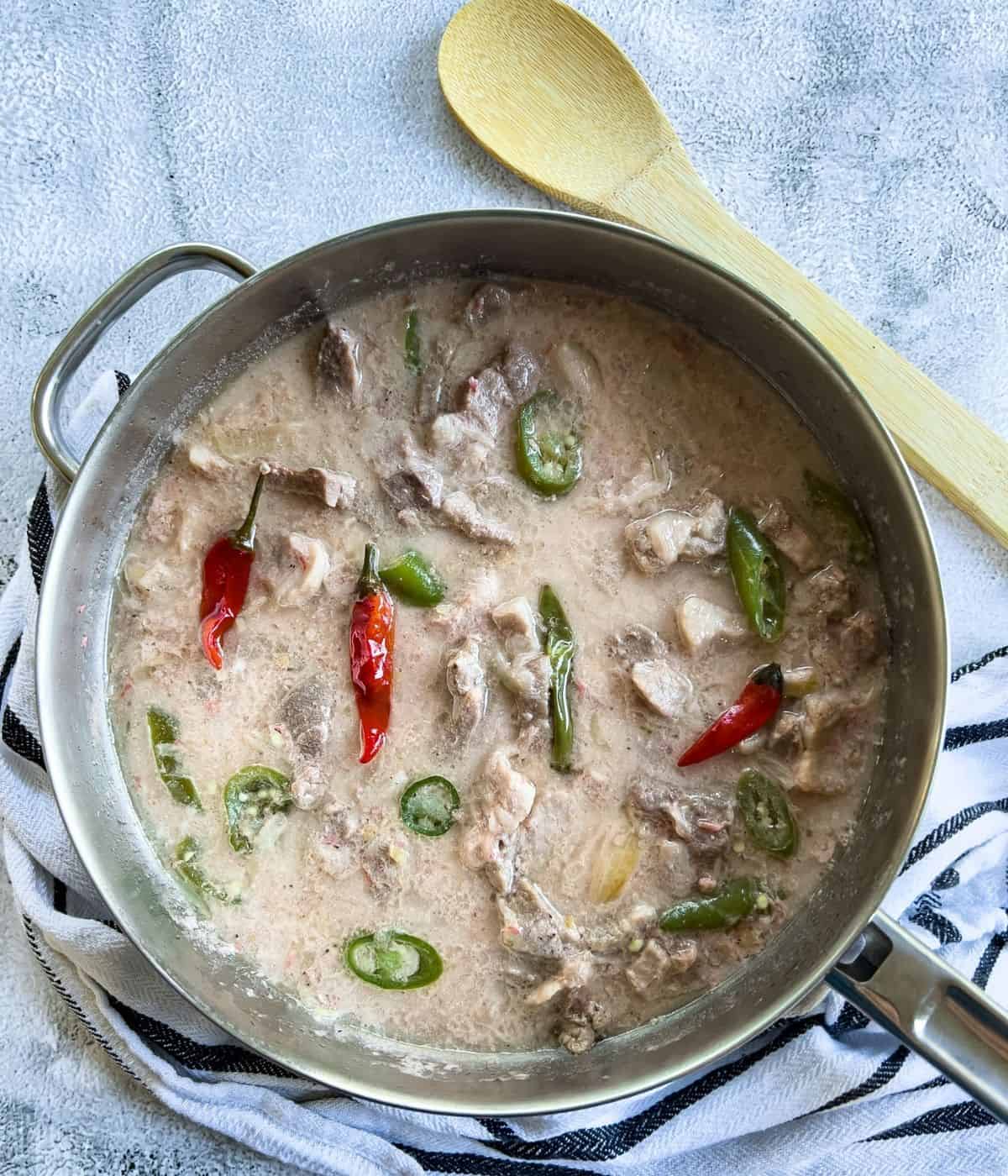 Pork bicol express in a skillet.