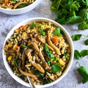 Mushroom vegetable fried rice on table.