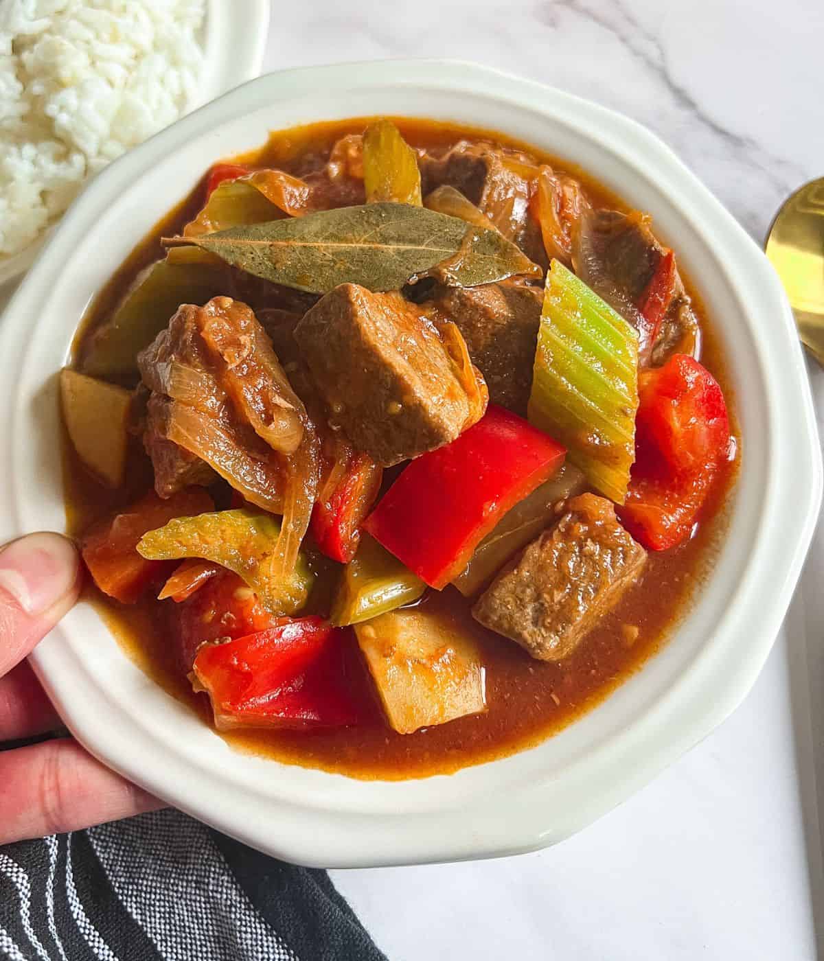 Delicious beef mechado on a plate.