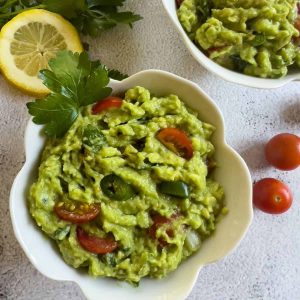 Finish dish of guacamole on the table.