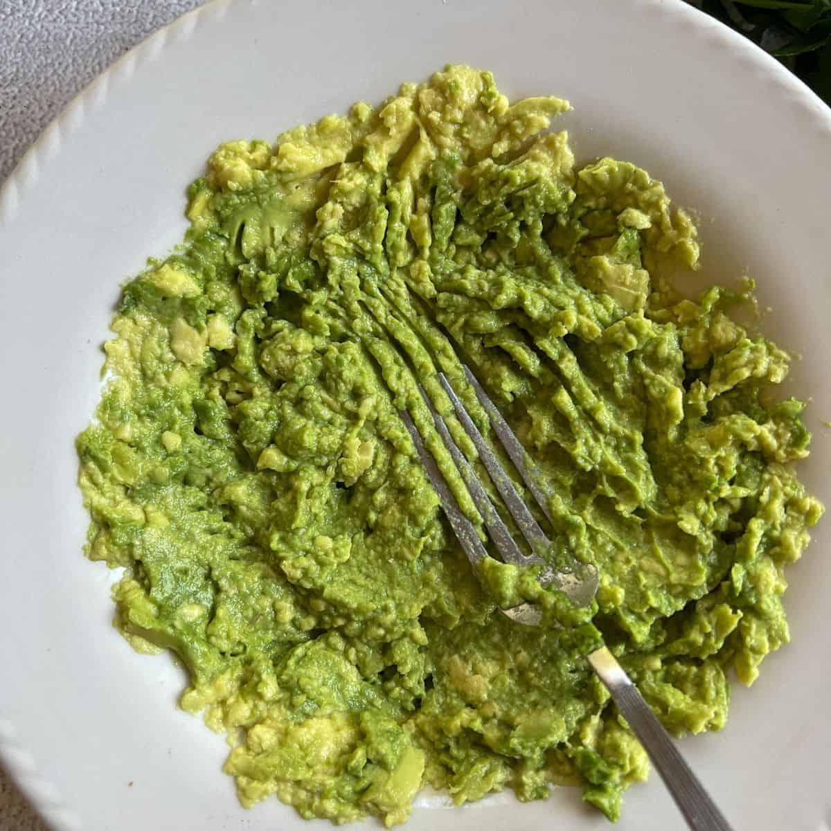 Mash avocado using a fork.