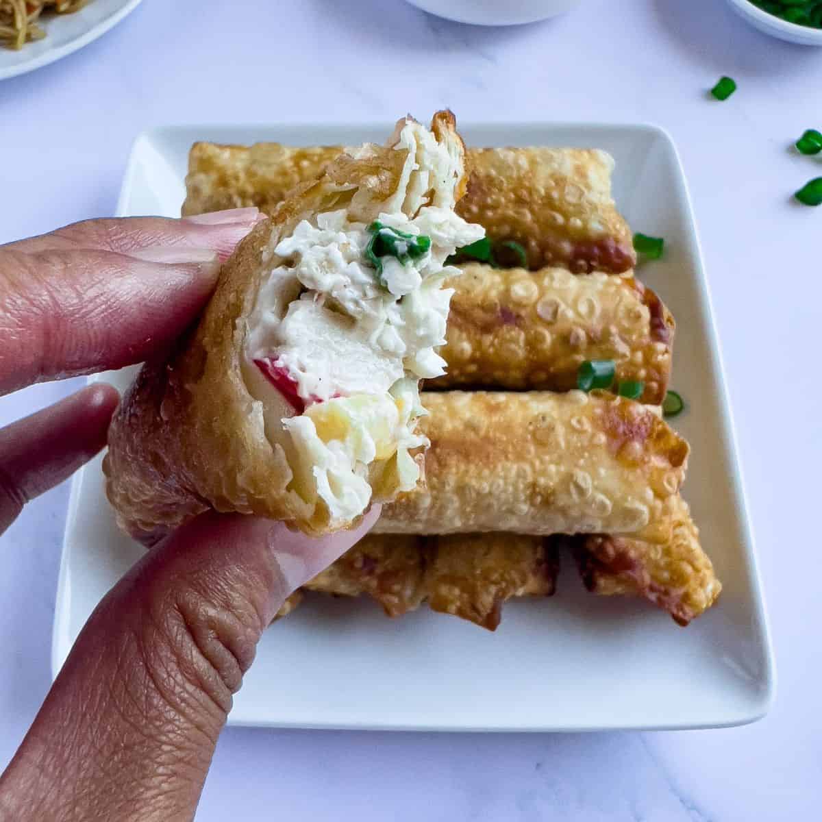 Crab rangoon egg rolls on the table.