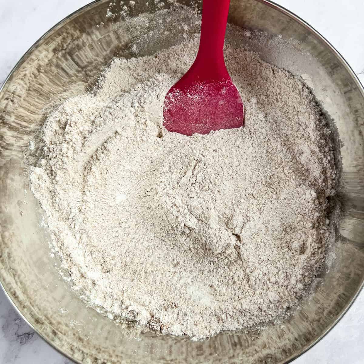 Combine the dry ingredients for pumpkin bread.