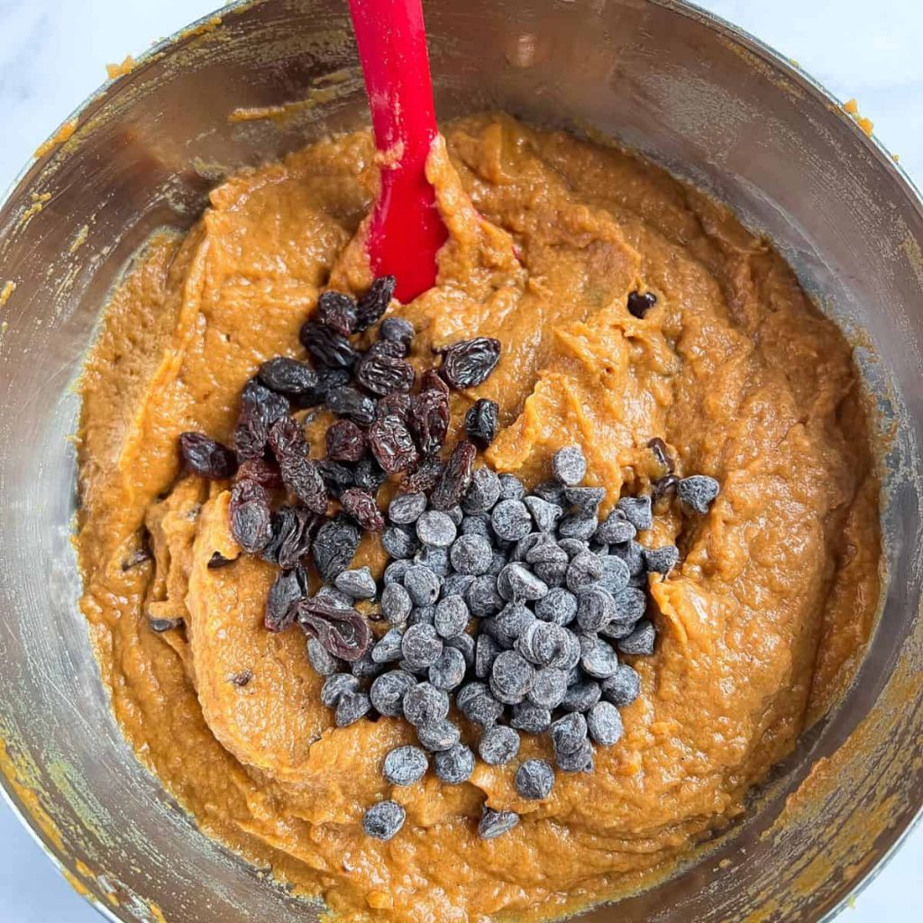 Combining all the ingredients to make pumpkin bread.