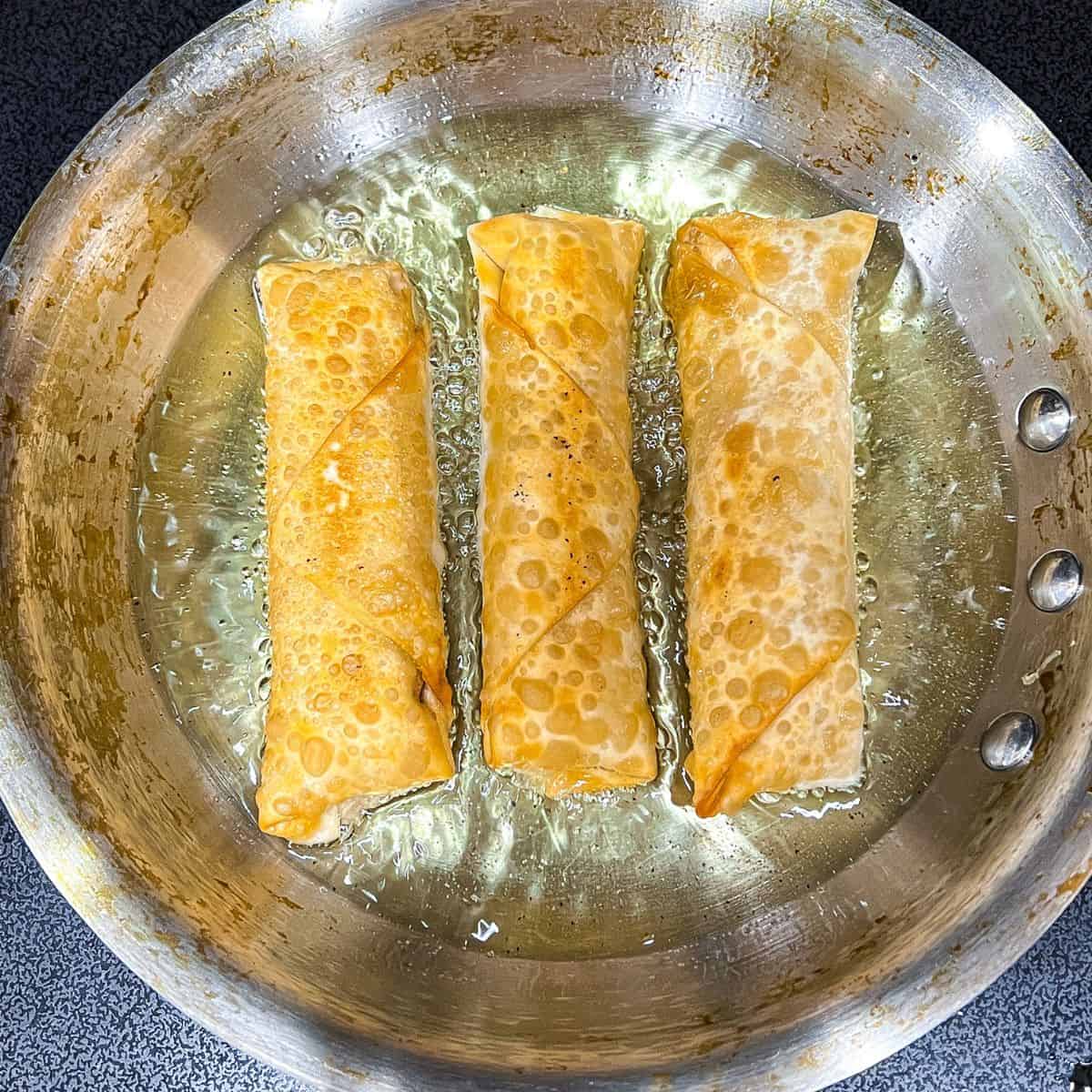 Deep frying eggrolls.