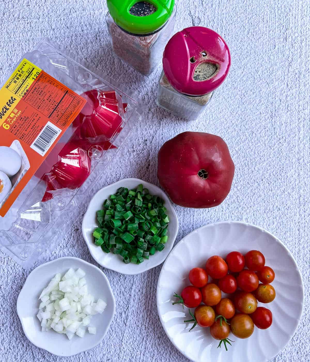 Ingredient list for salted egg with tomato salad.