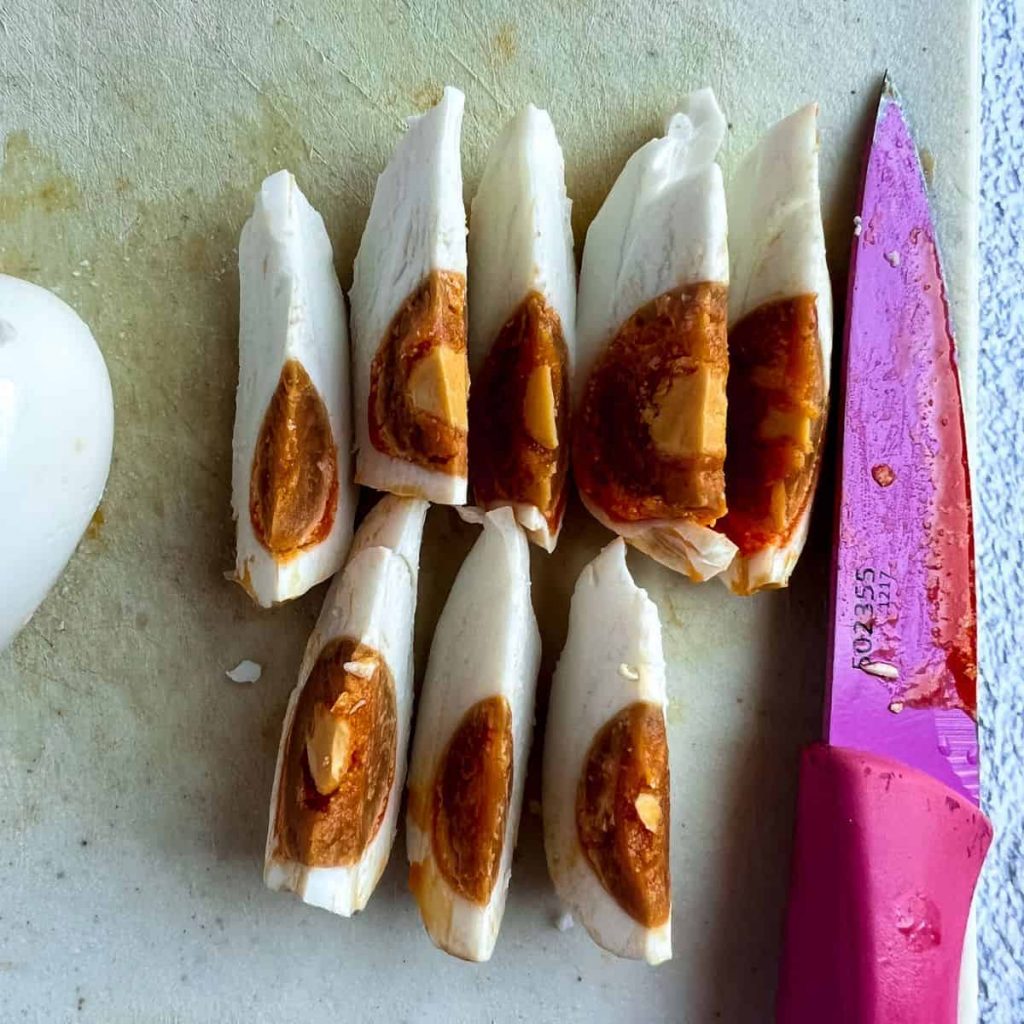 Sliced salted egg on a chopping board..
