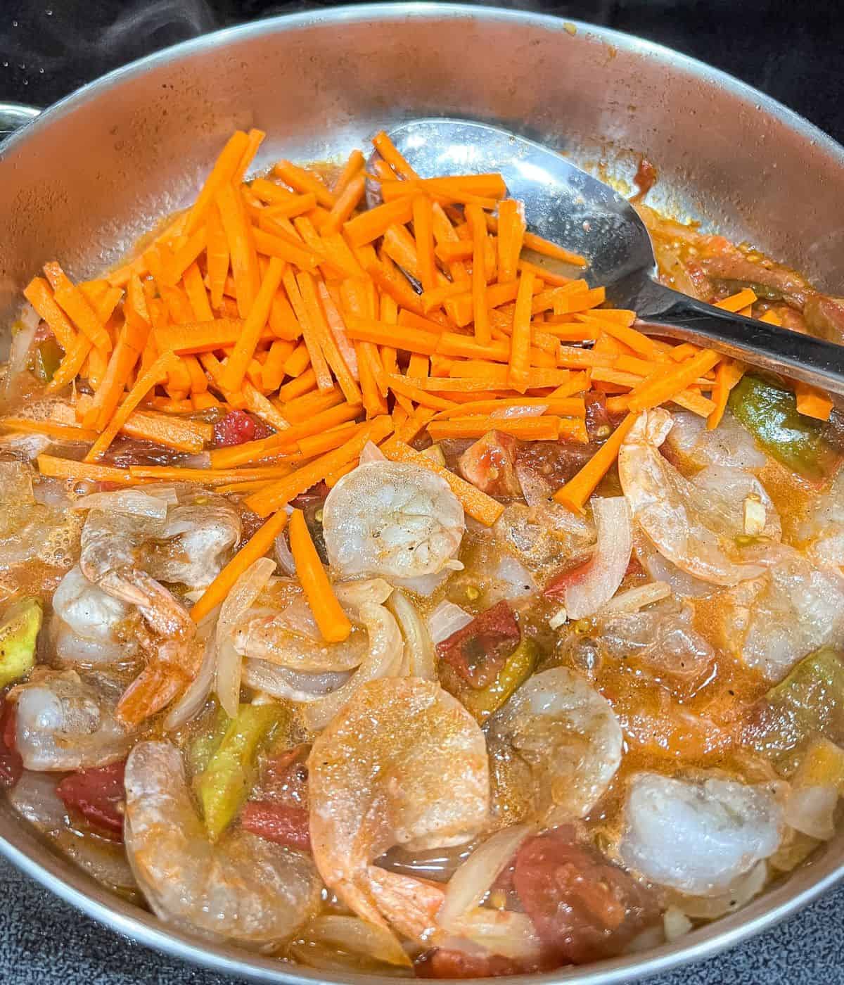 Adding carrots and shrimp.