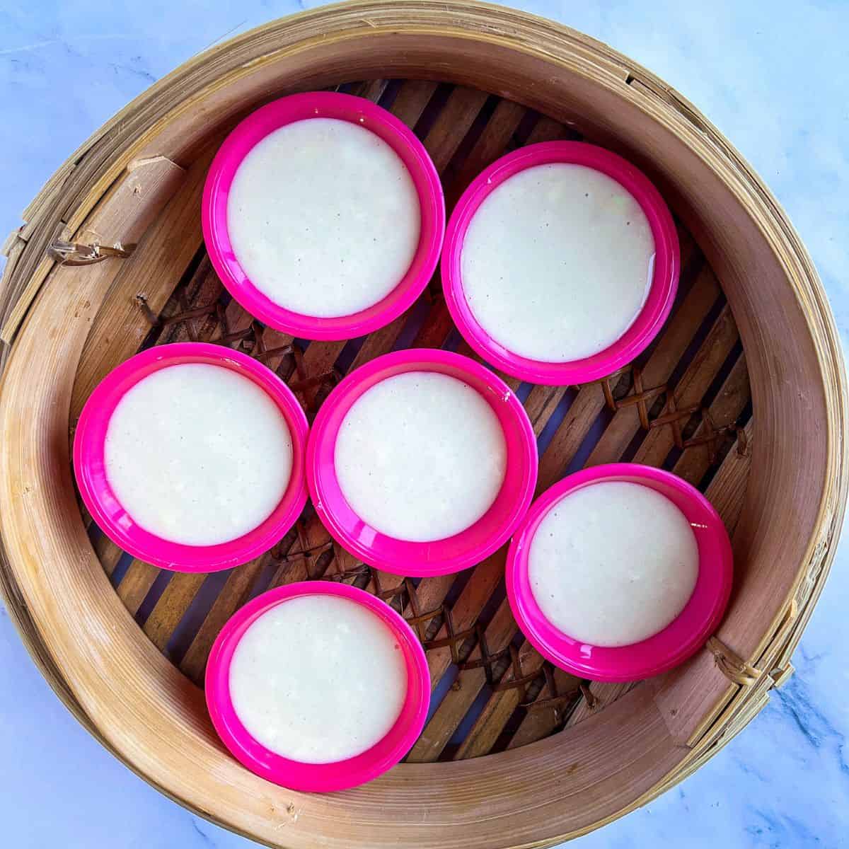 Steaming puto in a bambo steamer.