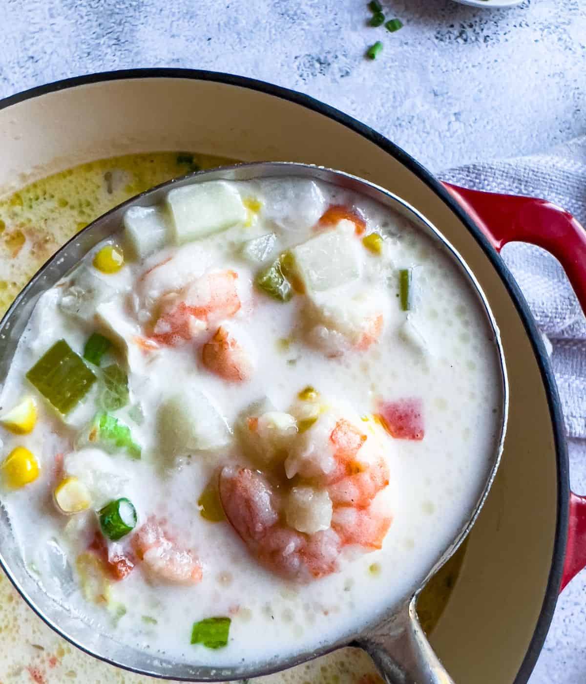 Finish dish of shrimp chowder in a dutch oven on the table.