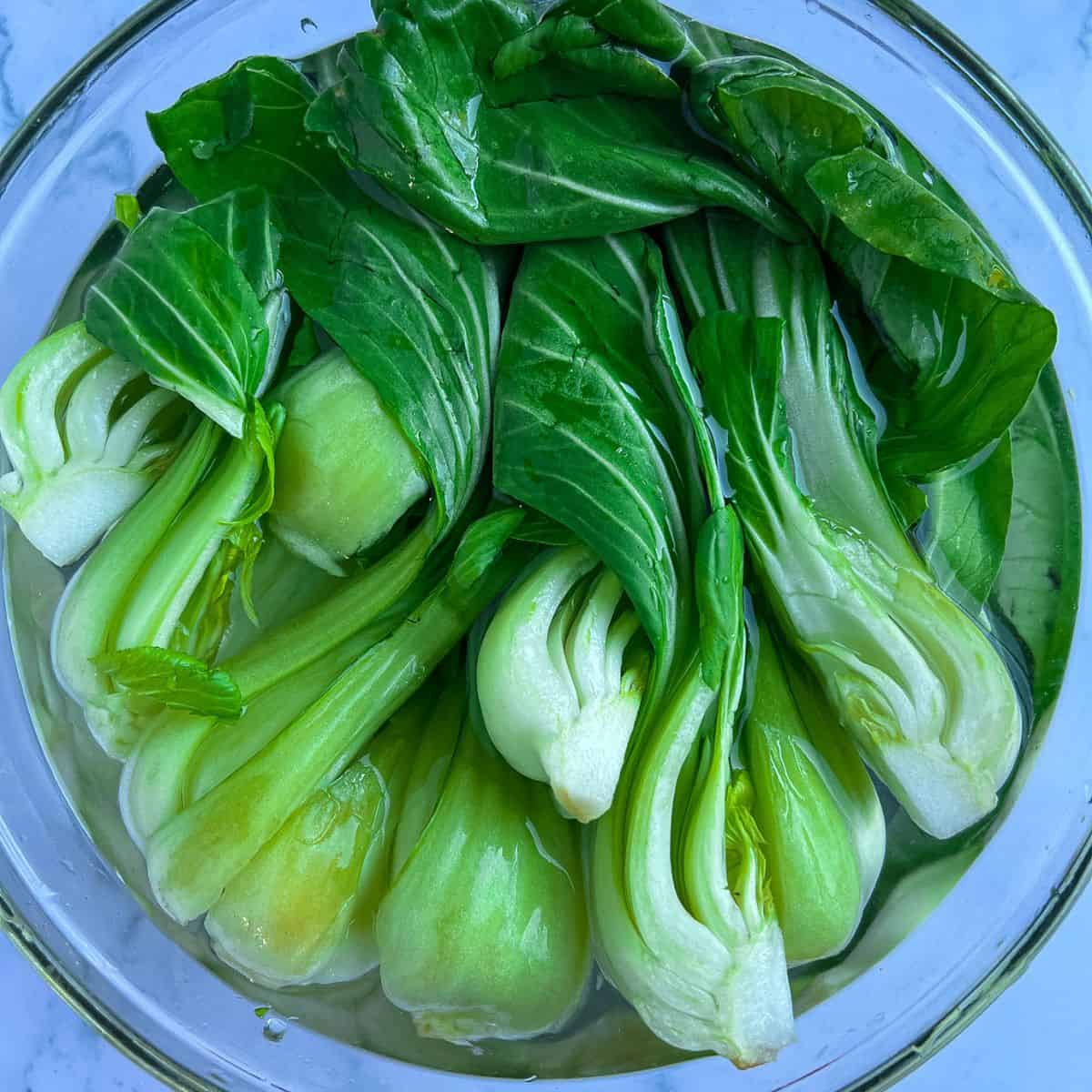 Soaking bok choy in salt water.