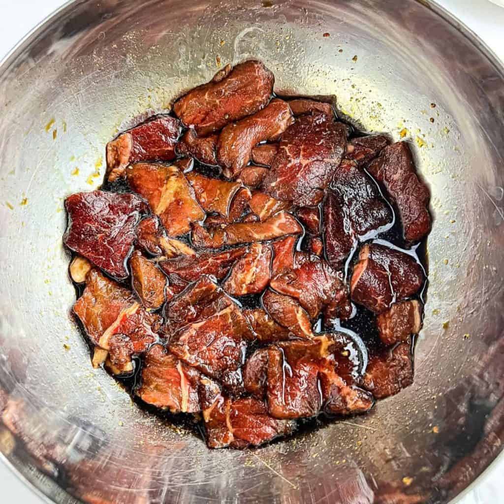 Marinate the beef with soy sauce, mirin, baking soda, and onion and garlic powder.