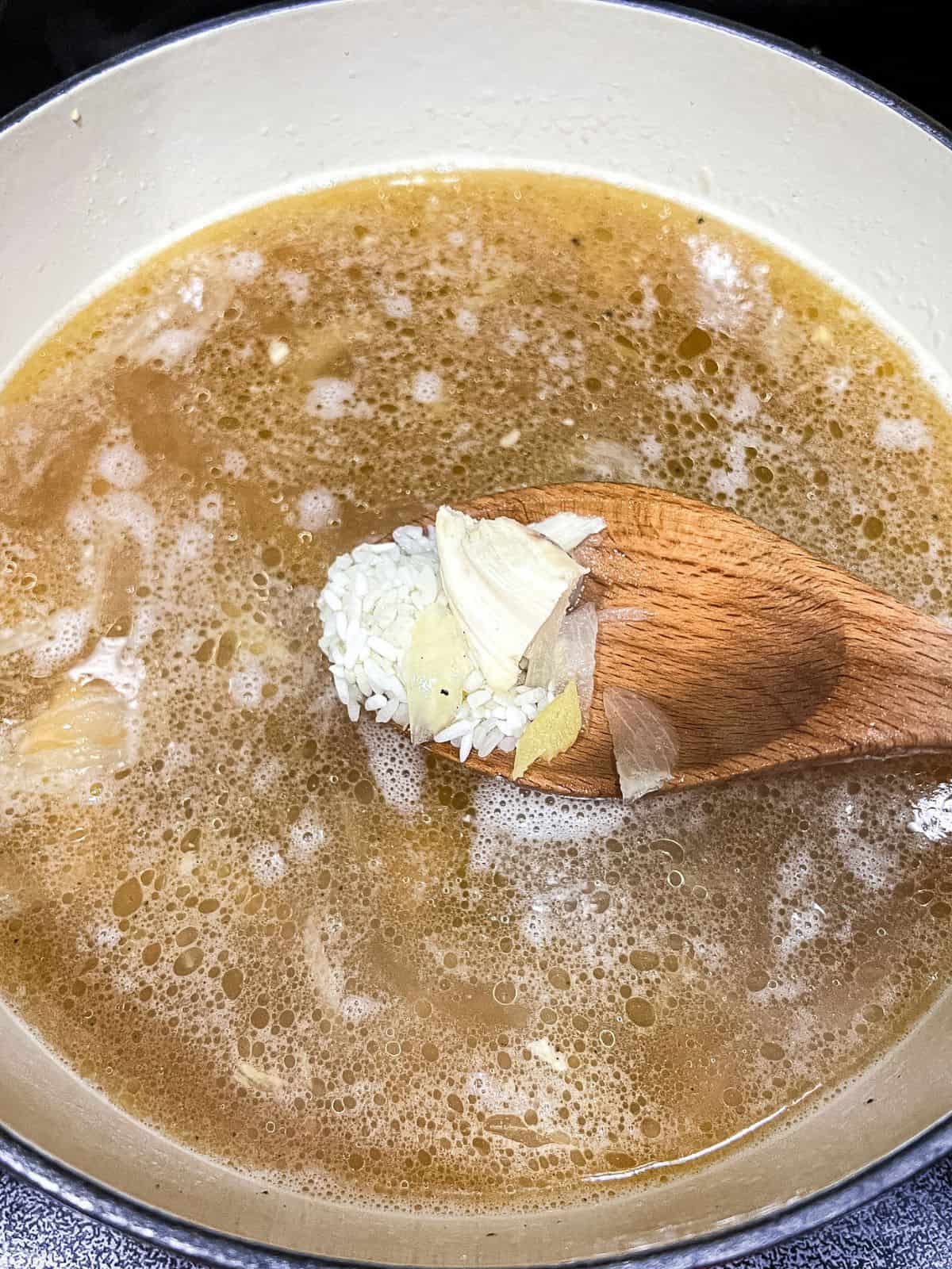 Cooking arroz caldo.