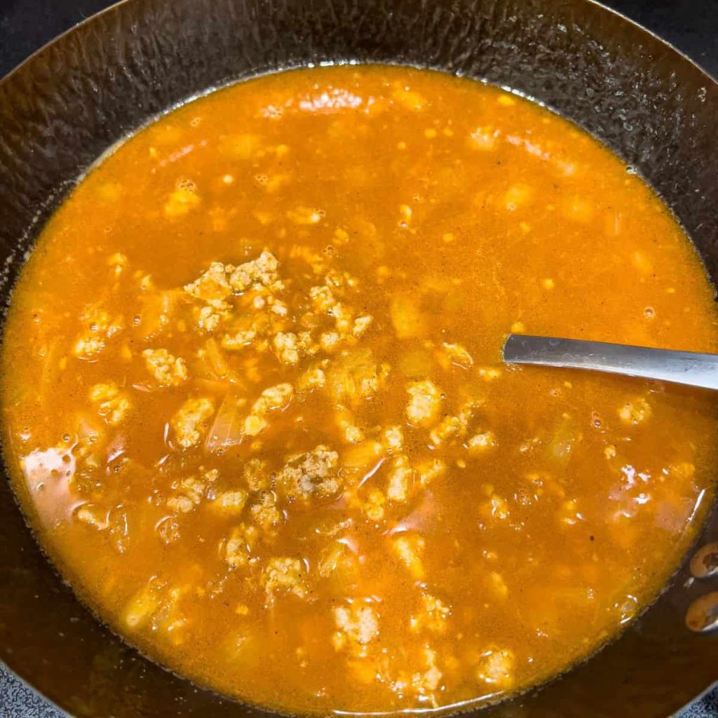 Cooking palabok sauce.