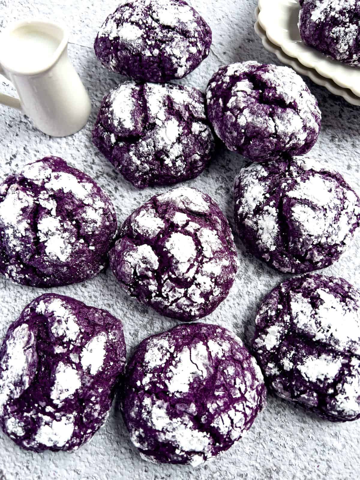 Ube crinkle cookies on the table with milk.
