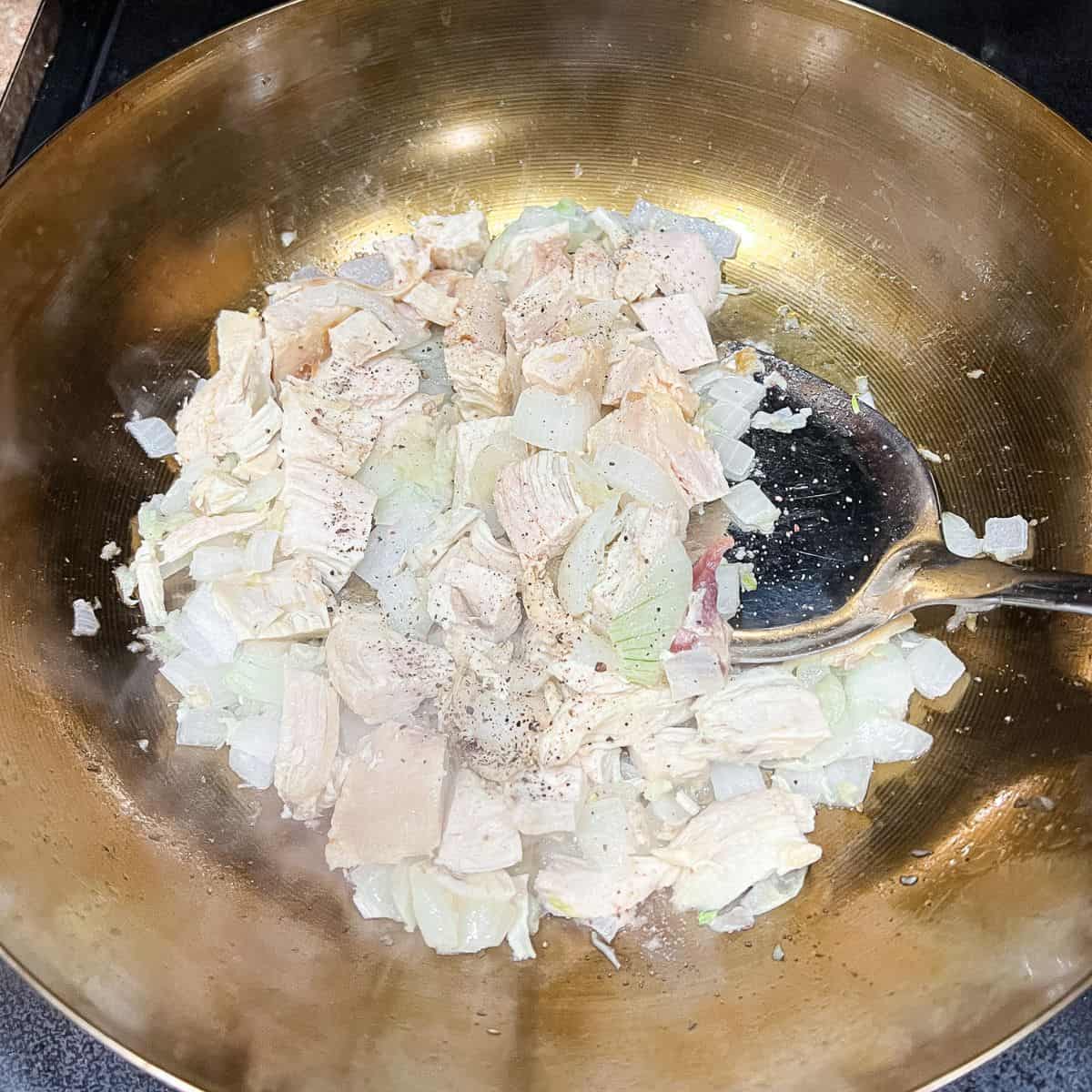 Cooked garlic, onion, and chicken for the pancit.