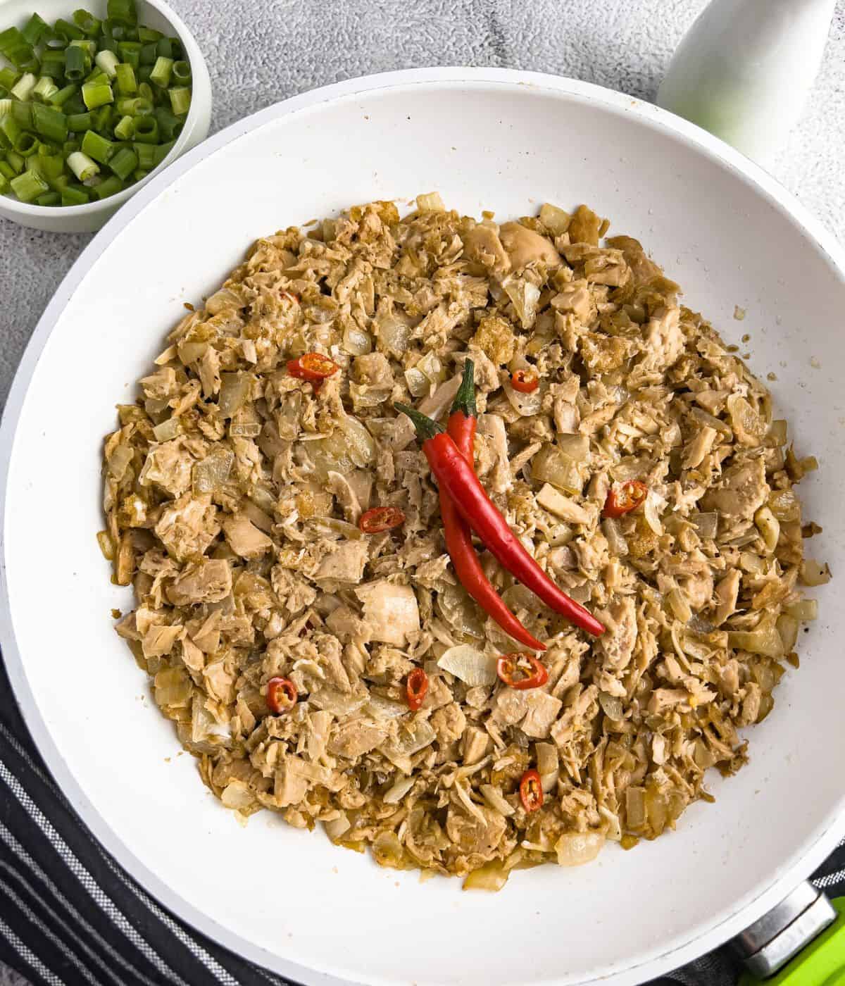 Finish dish of tuna sisig in skillet.