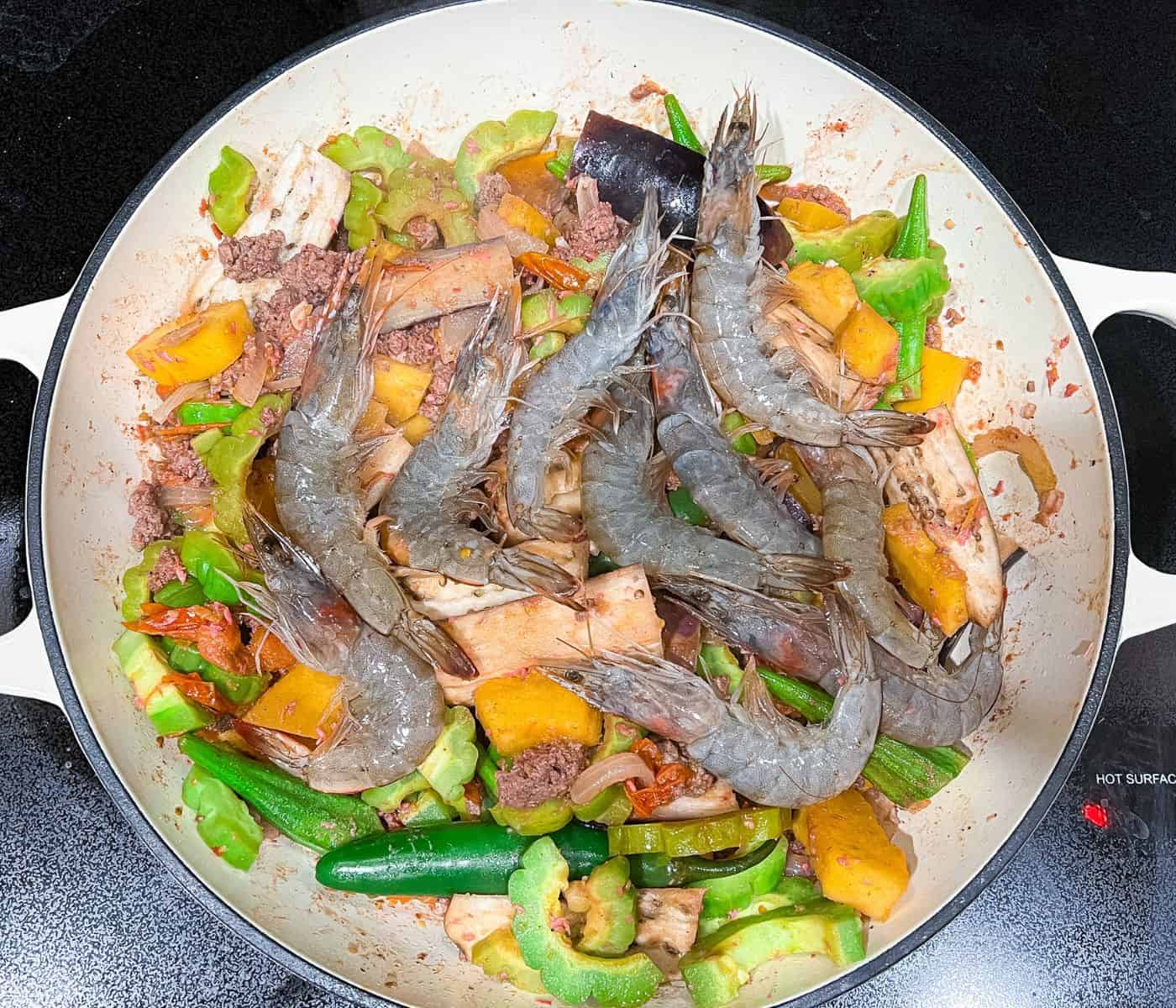 Adding shrimp at to finishing up the ginisang gulay dish.