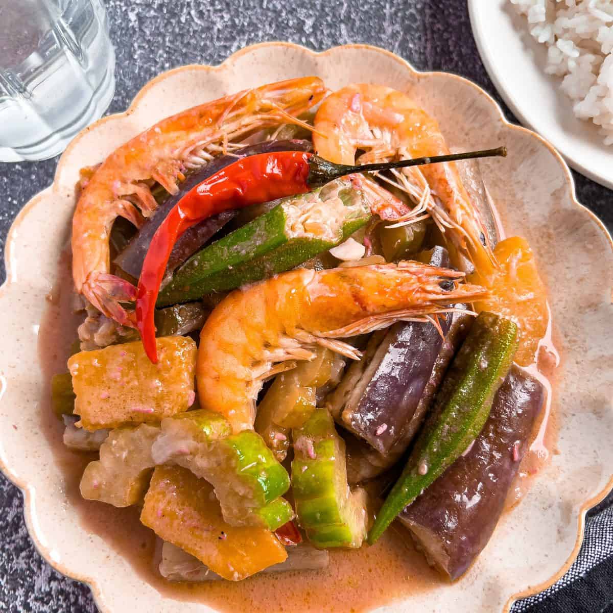 Finish dish of ginataang gulay in a plate with rice.
