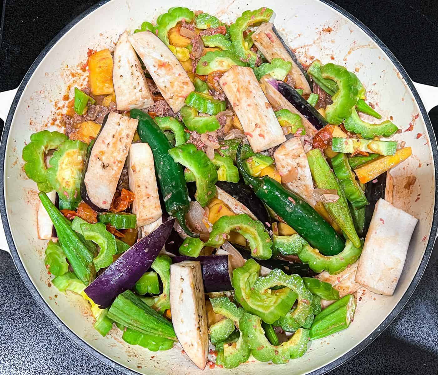 Adding the rest of the vegetables to cook the dish.