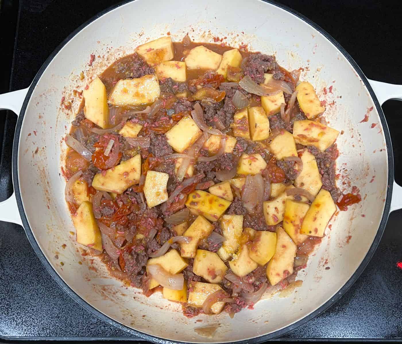 Adding squash to cook sauteed vegetables.