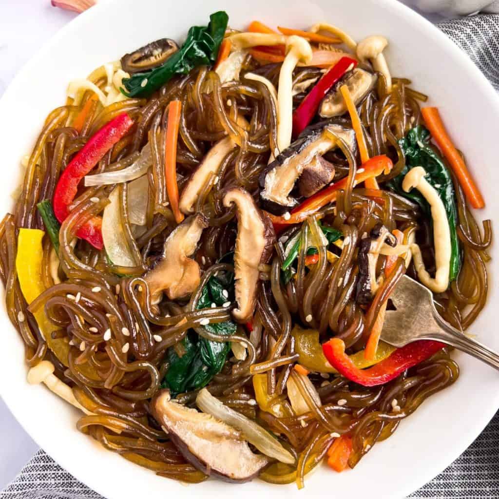 Finish dish of vegan japchae on the table.