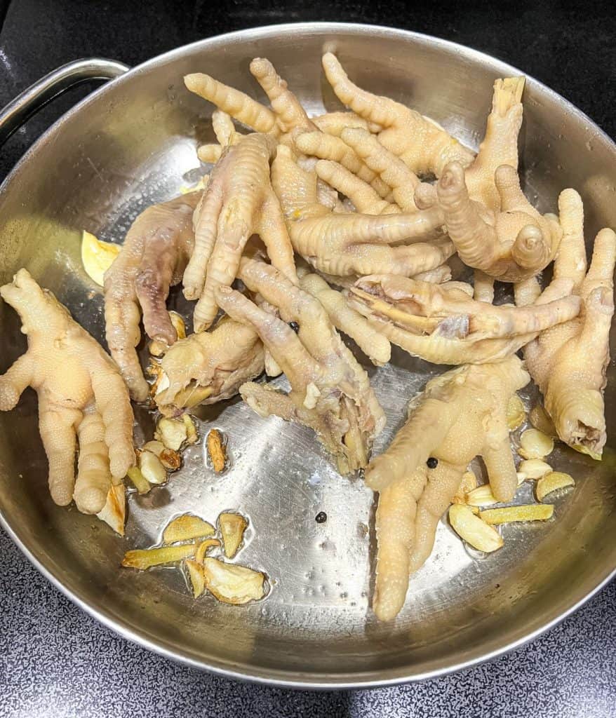 Saute garlic, onion, and ginger until translucent. Then add chicken feet.
