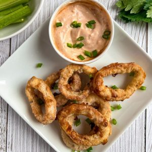 Finish dish of salt and pepper squid in a plate with sauce.